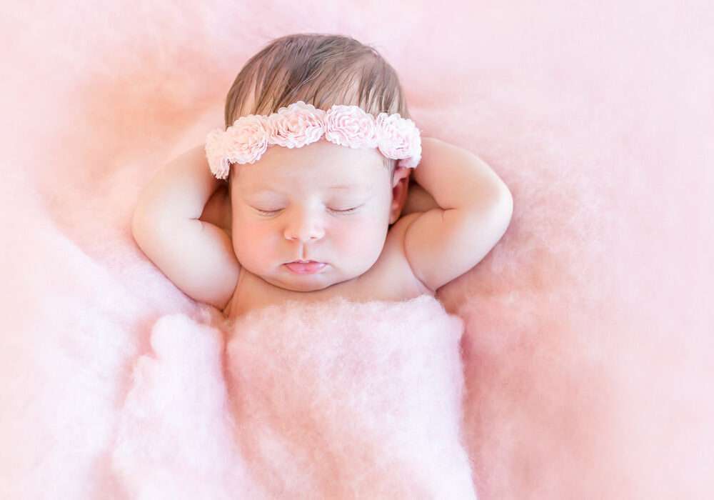 Newborn baby in pink cloud