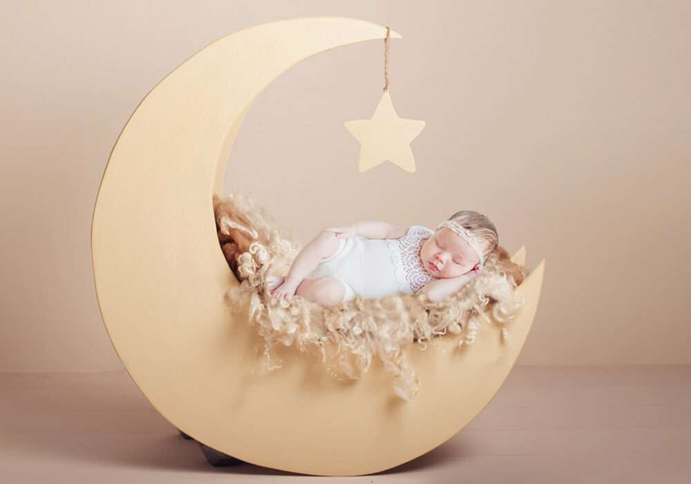 Newborn baby sleeping in moon